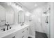Bathroom featuring double sinks, white cabinets, modern fixtures, and a glass-enclosed shower at 1924 Sean Wood Cir, Brandon, FL 33510
