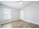 This is a bedroom with light gray walls, laminate floors, a ceiling fan and a window at 1924 Sean Wood Cir, Brandon, FL 33510