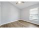 This is a bedroom with light gray walls, laminate floors, a ceiling fan and a window at 1924 Sean Wood Cir, Brandon, FL 33510