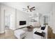 Open-concept living room with modern decor, ceiling fan, and views into the kitchen at 1924 Sean Wood Cir, Brandon, FL 33510