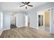 Large bedroom with ceiling fan, plank flooring and modern bathroom and walk-in closet at 1924 Sean Wood Cir, Brandon, FL 33510