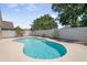 Kidney-shaped pool in backyard with landscaping around the white fence at 1924 Sean Wood Cir, Brandon, FL 33510