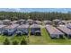 Scenic aerial view of homes in a suburban neighborhood featuring lush green lawns and mature trees at 21003 Monza Loop, Land O Lakes, FL 34638