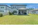 Spacious backyard with lush green grass and a covered patio perfect for outdoor entertaining at 21003 Monza Loop, Land O Lakes, FL 34638