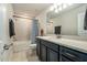 The bathroom features a vanity with a white countertop and dark blue cabinets at 21003 Monza Loop, Land O Lakes, FL 34638