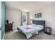 Bright bedroom featuring a bed, side tables, a desk, and a serene window view at 21003 Monza Loop, Land O Lakes, FL 34638