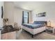 Cozy bedroom with neutral tones, a comfortable bed, side table, and a large window at 21003 Monza Loop, Land O Lakes, FL 34638