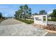 Community entrance sign for Arden Preserve with palm trees and a stone paver driveway at 21003 Monza Loop, Land O Lakes, FL 34638
