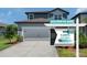 Charming two-story home with a two-car garage and beautifully landscaped front yard at 21003 Monza Loop, Land O Lakes, FL 34638
