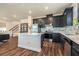 Updated kitchen boasts navy cabinets, stainless steel appliances, quartz countertops, and a convenient center island at 21003 Monza Loop, Land O Lakes, FL 34638