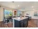Open-concept kitchen with a center island, dining area, and a seamless flow into the living space at 21003 Monza Loop, Land O Lakes, FL 34638
