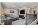 Comfortable upstairs living area with plush seating, a large TV, and decorative wrought iron banister at 21003 Monza Loop, Land O Lakes, FL 34638