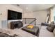 Upstairs living room with comfy seating, a large TV, and wrought iron bannister at 21003 Monza Loop, Land O Lakes, FL 34638