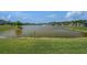 Scenic view of a tranquil pond surrounded by lush greenery and beautiful homes at 21003 Monza Loop, Land O Lakes, FL 34638