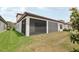 Back exterior view shows lanai, landscaping, and neutral color, enhancing the home's outdoor appeal at 21746 Amelia Rose Way, Land O Lakes, FL 34637