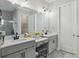 Elegant bathroom with double sinks, white cabinets, granite countertops, and modern fixtures at 21746 Amelia Rose Way, Land O Lakes, FL 34637