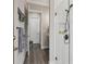 Hallway to bathroom features a tile shower, decorative towel rack, and neutral paint at 21746 Amelia Rose Way, Land O Lakes, FL 34637