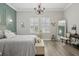 Bright bedroom boasts ample natural light, wood floors, and designer furnishings at 21746 Amelia Rose Way, Land O Lakes, FL 34637