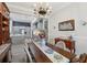 Formal dining room flows to the kitchen with gorgeous hardwood floors and decorative chandelier at 21746 Amelia Rose Way, Land O Lakes, FL 34637