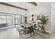 Bright dining room boasts wood beams, modern lighting, and sliding doors to the outdoor space at 21746 Amelia Rose Way, Land O Lakes, FL 34637