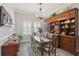 Elegant dining room features wooden furniture, built-in shelving, and natural light from shuttered windows at 21746 Amelia Rose Way, Land O Lakes, FL 34637