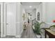 Hallway with fresh paint, decor, and wood-look floors leading to the living space at 21746 Amelia Rose Way, Land O Lakes, FL 34637