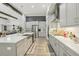 Contemporary kitchen featuring stainless appliances, white counters and seamless flow to dining area at 21746 Amelia Rose Way, Land O Lakes, FL 34637