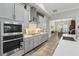 Modern kitchen with gray cabinets, stainless steel appliances and a view into the dining area at 21746 Amelia Rose Way, Land O Lakes, FL 34637