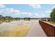 Scenic lake view with a wooden dock and gazebo, perfect for relaxation and enjoying waterfront living at 21746 Amelia Rose Way, Land O Lakes, FL 34637