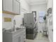 Laundry room with modern appliances and a sink, adding convenience and functionality at 21746 Amelia Rose Way, Land O Lakes, FL 34637