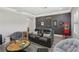 Cozy living room features a stylish, comfortable leather couch and a vintage popcorn machine at 21746 Amelia Rose Way, Land O Lakes, FL 34637