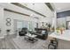 Open-concept living room featuring wood-look floors, exposed beams, and modern furniture at 21746 Amelia Rose Way, Land O Lakes, FL 34637
