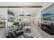 Open living space with a modern kitchen, dining area, and comfortable seating area with a TV at 21746 Amelia Rose Way, Land O Lakes, FL 34637