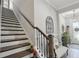 Staircase with dark wood stairs and decorative iron railing leading to the upper level of the home at 21746 Amelia Rose Way, Land O Lakes, FL 34637