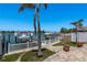 Picturesque backyard with waterfront views, boat dock, and mature landscaping. Perfect for outdoor enjoyment at 2202 Donato Dr, Belleair Beach, FL 33786