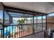 Balcony with a view of the pool and waterfront featuring outdoor seating and a relaxed ambiance at 2202 Donato Dr, Belleair Beach, FL 33786