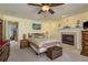Cozy bedroom features plush carpeting, a decorative fireplace, and a comfortable queen-size bed with accent pillows at 2202 Donato Dr, Belleair Beach, FL 33786