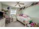Bright bedroom features a twin bed, a decorative desk, and charming decor elements with natural lighting at 2202 Donato Dr, Belleair Beach, FL 33786