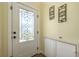 Entryway with decorative glass door and iron wall hangings, showcasing unique style and welcoming ambiance at 2202 Donato Dr, Belleair Beach, FL 33786