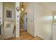 A hallway with light-yellow walls, hardwood floors, and a staircase leading to the upper level at 2202 Donato Dr, Belleair Beach, FL 33786
