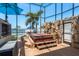 Relaxing outdoor hot tub with stone accents in screened-in patio with beautiful water views at 2202 Donato Dr, Belleair Beach, FL 33786