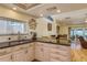Bright kitchen features granite countertops, stainless steel sink, and views of the water through a large window at 2202 Donato Dr, Belleair Beach, FL 33786