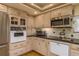 Traditional kitchen featuring stainless steel appliances and granite countertops at 2202 Donato Dr, Belleair Beach, FL 33786