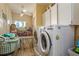 Functional laundry room with washer, dryer, and ample storage space to keep your space clean and organized at 2202 Donato Dr, Belleair Beach, FL 33786