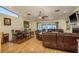 Spacious living room featuring hardwood floors, comfortable seating, and sliders to the lanai at 2202 Donato Dr, Belleair Beach, FL 33786