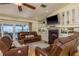 Comfortable living room featuring a fireplace, hardwood floors, and sliders to the lanai at 2202 Donato Dr, Belleair Beach, FL 33786