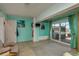 Bright living room with tiled floors, water view, and glass doors to an outdoor patio at 2202 Donato Dr, Belleair Beach, FL 33786