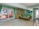 Casual living room provides comfortable seating, natural light, and views of the patio and canal at 2202 Donato Dr, Belleair Beach, FL 33786