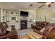 Cozy living room with a fireplace, comfortable seating, and mirrored shelving units at 2202 Donato Dr, Belleair Beach, FL 33786