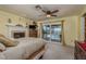 Comfortable main bedroom featuring a fireplace and sliders to a private balcony at 2202 Donato Dr, Belleair Beach, FL 33786